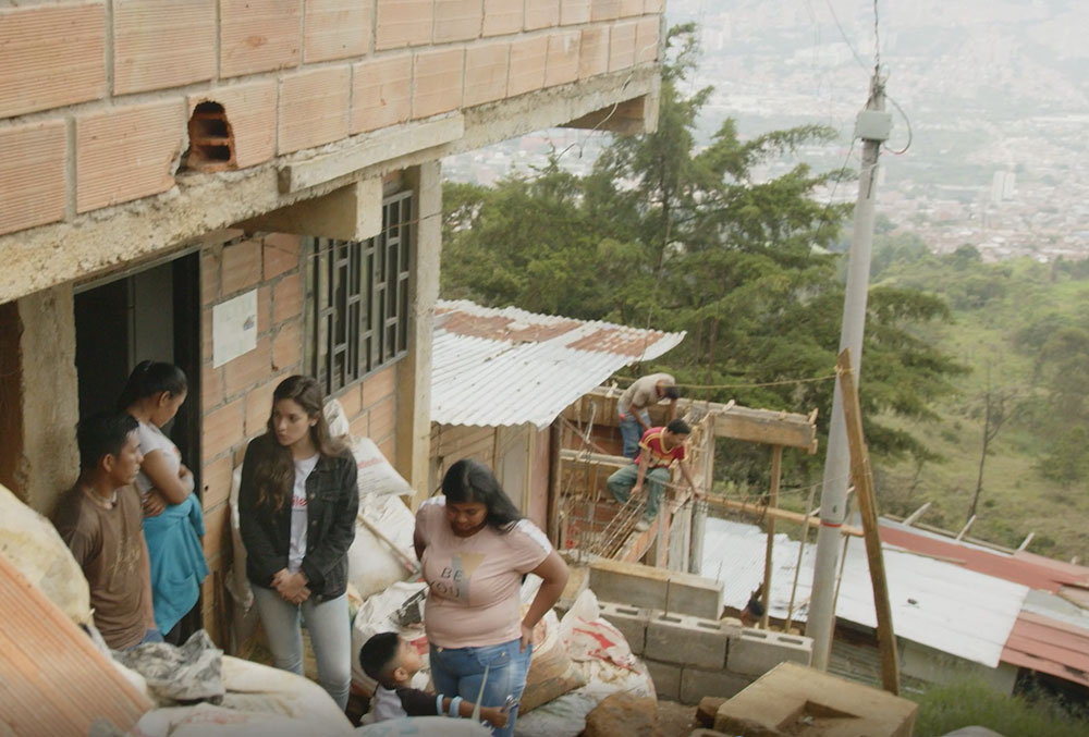 Camila osorio speaking with mathias' family outside their home