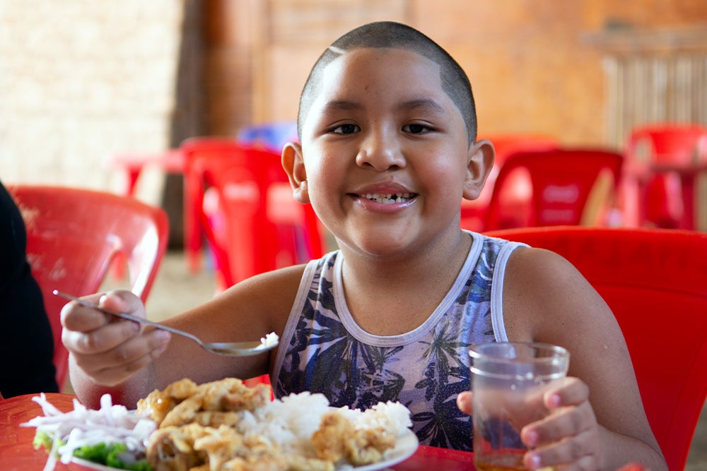 Ramses smiling and eating lunch