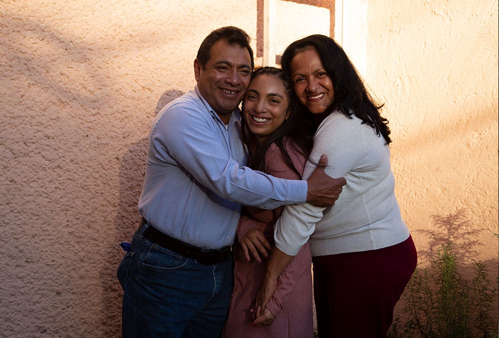 Adahara smiling with her parents after her cleft surgery