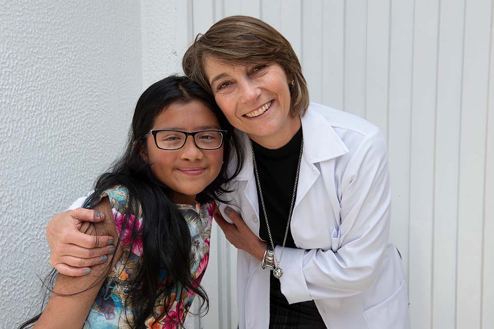 Dr. Maria del Pilar smiling and hugging Monica