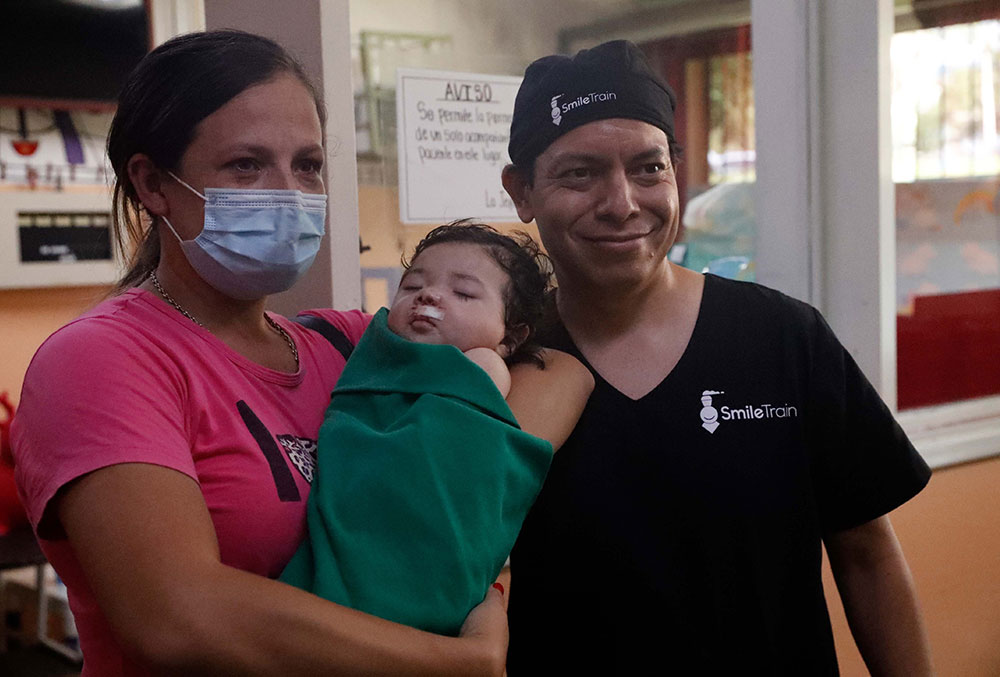 Cinthia holding Gianna with Dr. Aldana after Gianna's cleft surgery