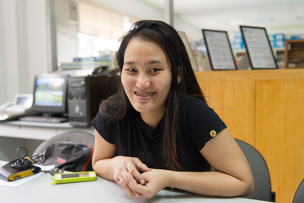 Gracee smiling at a desk