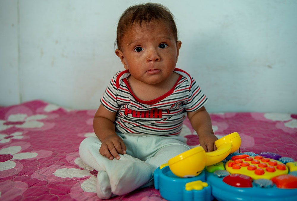 joseyur playing with a toy after cleft surgery