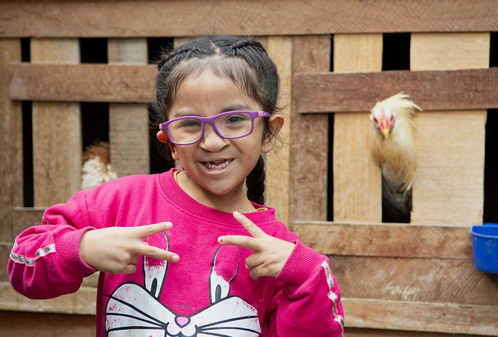 Kristhell posing in front of chickens