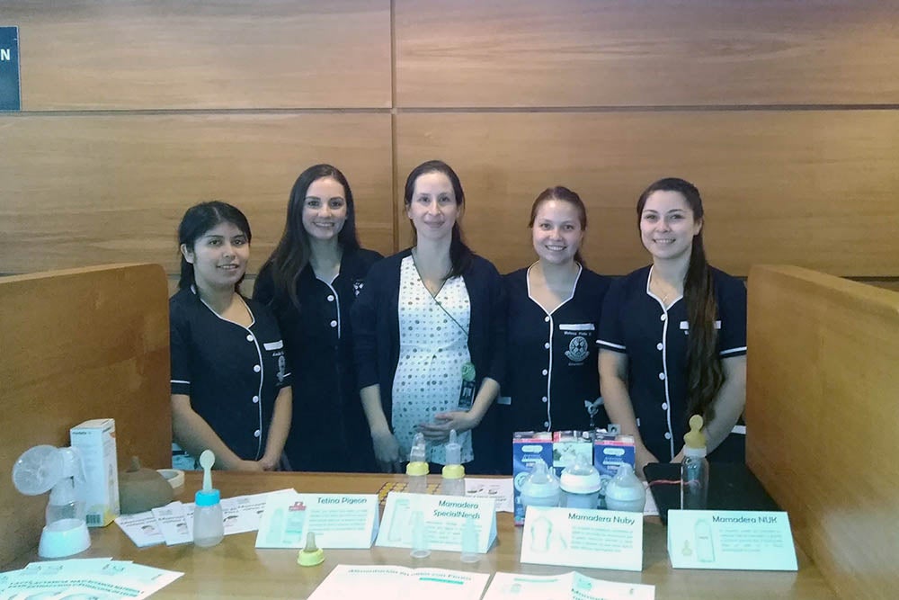 Lisette smiling with nurses