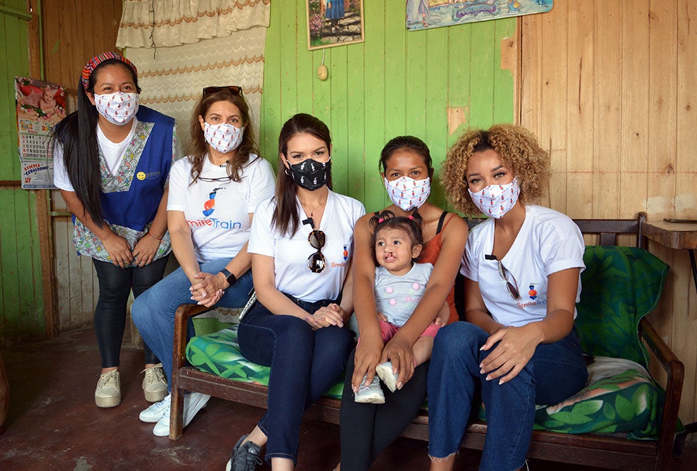 Yely Rivera and Elle Smith smiling with Jenifer's family at MCF