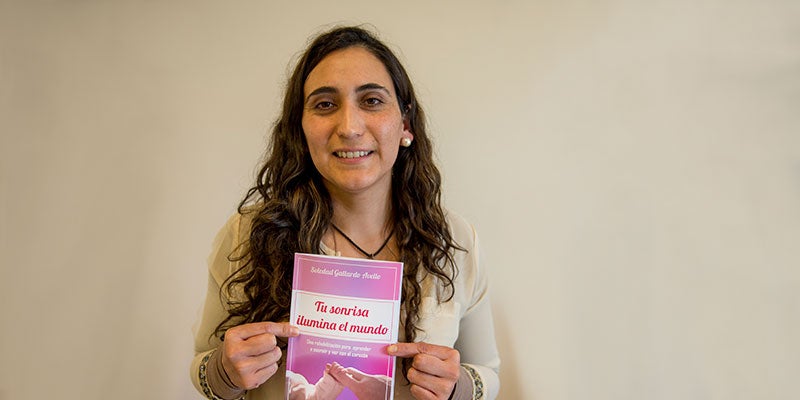 Soledad sonriendo con su libro