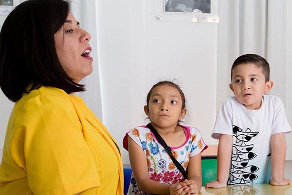 Gael listening to his teacher in speech workshop