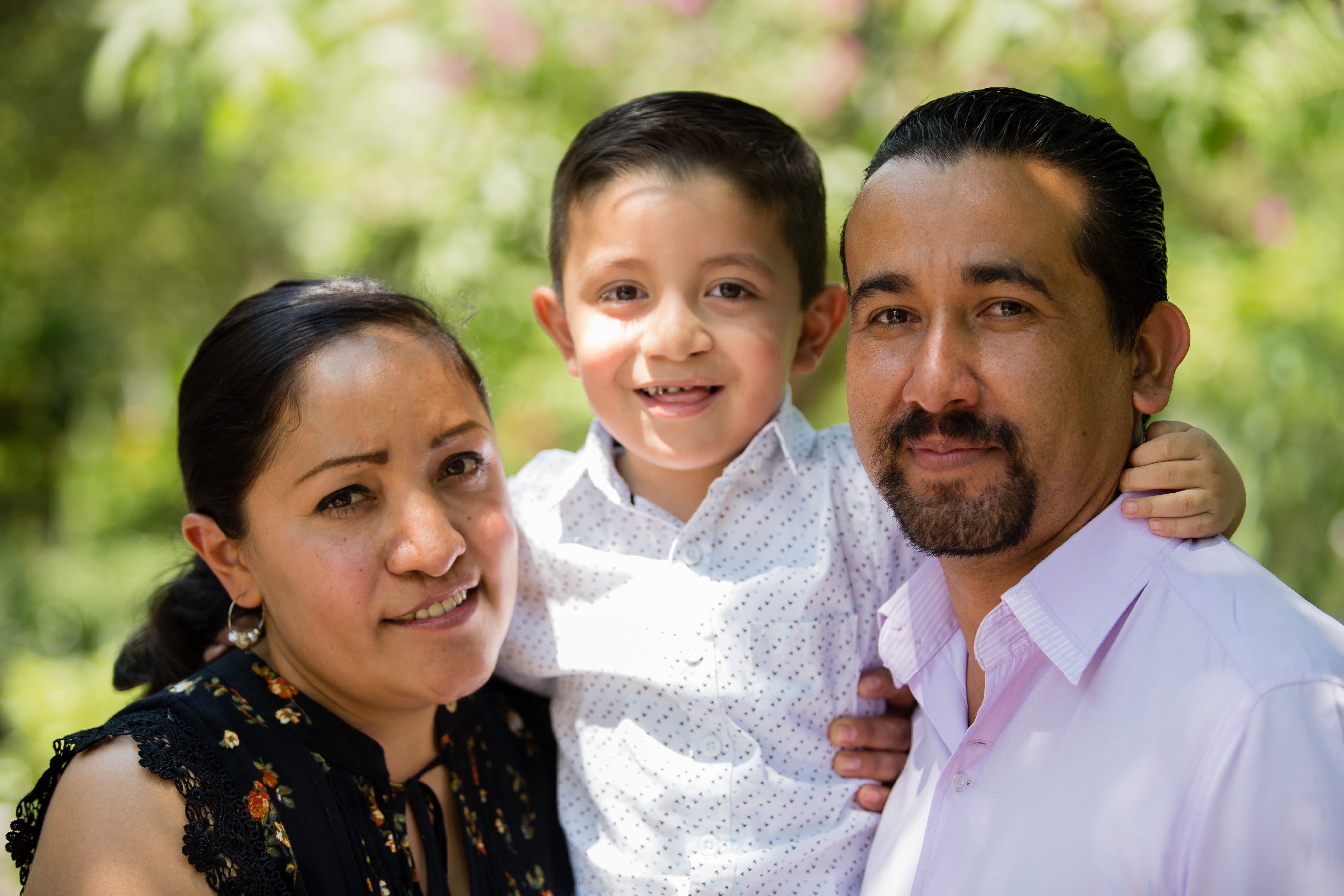 Gael smiling with his parents