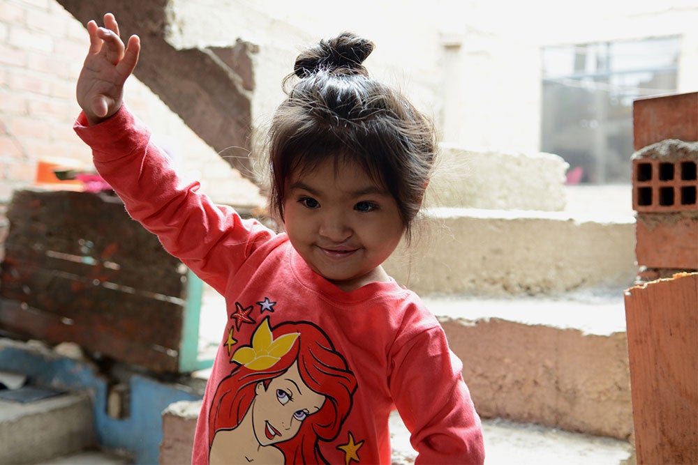 Shaymi smiling and waving after cleft surgery