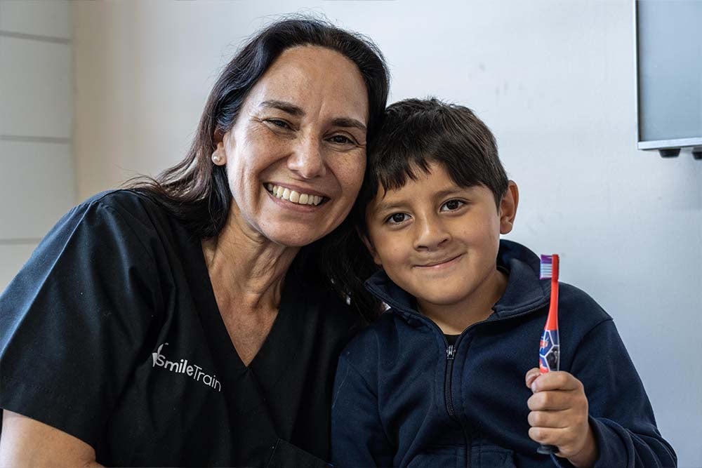 Ezequiel smiles alongside one of his doctors
