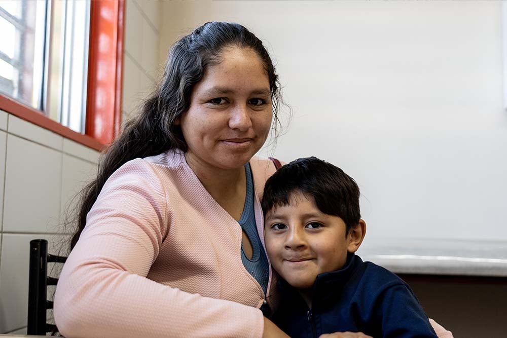 Silvia and Ezequiel share a hug and smile for the camera