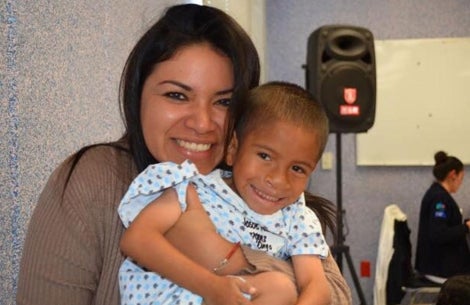 Karla holding a patient and smiling