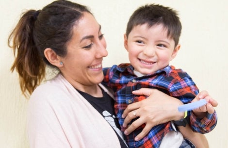 andrea holding a patient and smiling