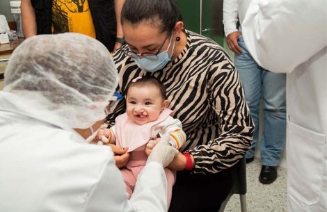 cleft patient smiling with her mother