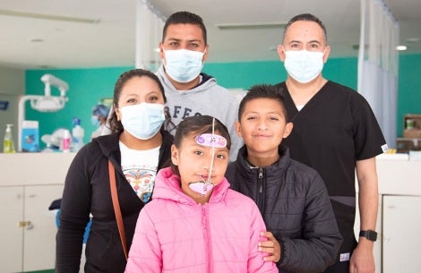 Alex and Kendra smiling with their family