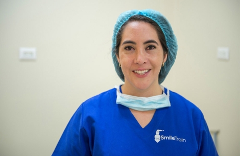 Dr. Andrea Astudillo smiling in scrubs