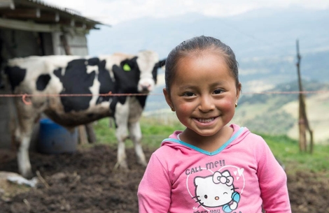 Fernanda smiling in front of a cow