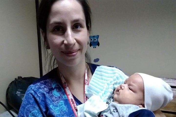 Lisette Jerez smiling and holding a cleft patient