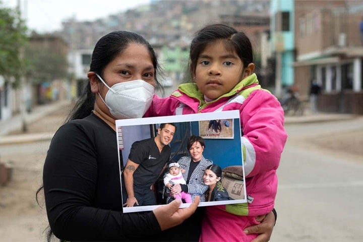 Mia and Luz hold a picture of her before cleft surgery with Kylie and Kris Jenner