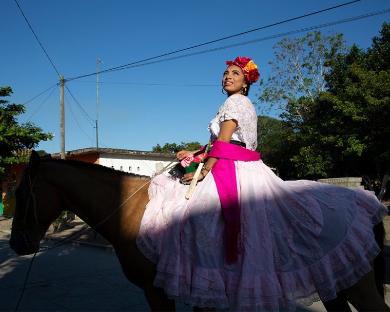 Adahara on a horse smiling after cleft surgery