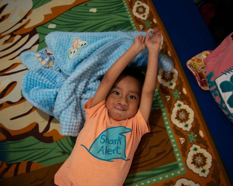 Anghelo laying on a blanket after cleft surgery