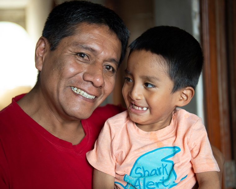 Anghelo smiling with his father
