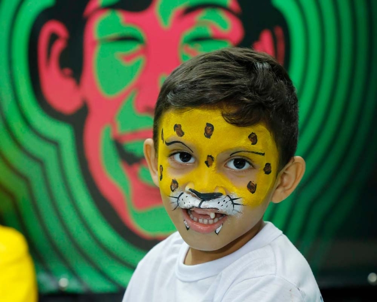child smiling with facepaint on